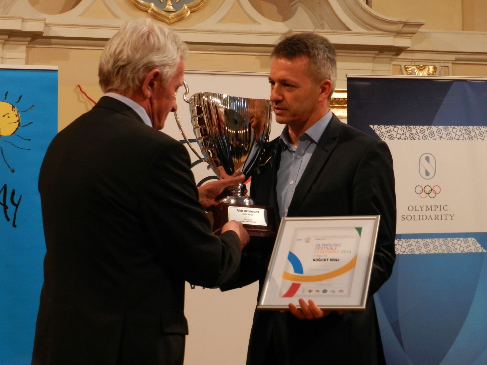 Z rúk prezidenta SOV Františka Chmelára si preberá Pohár prezidenta SOV šéf odboru školstva Košického samosprávneho kraja Štefan Kandráč. FOTO MOJMÍR GAŠKO
